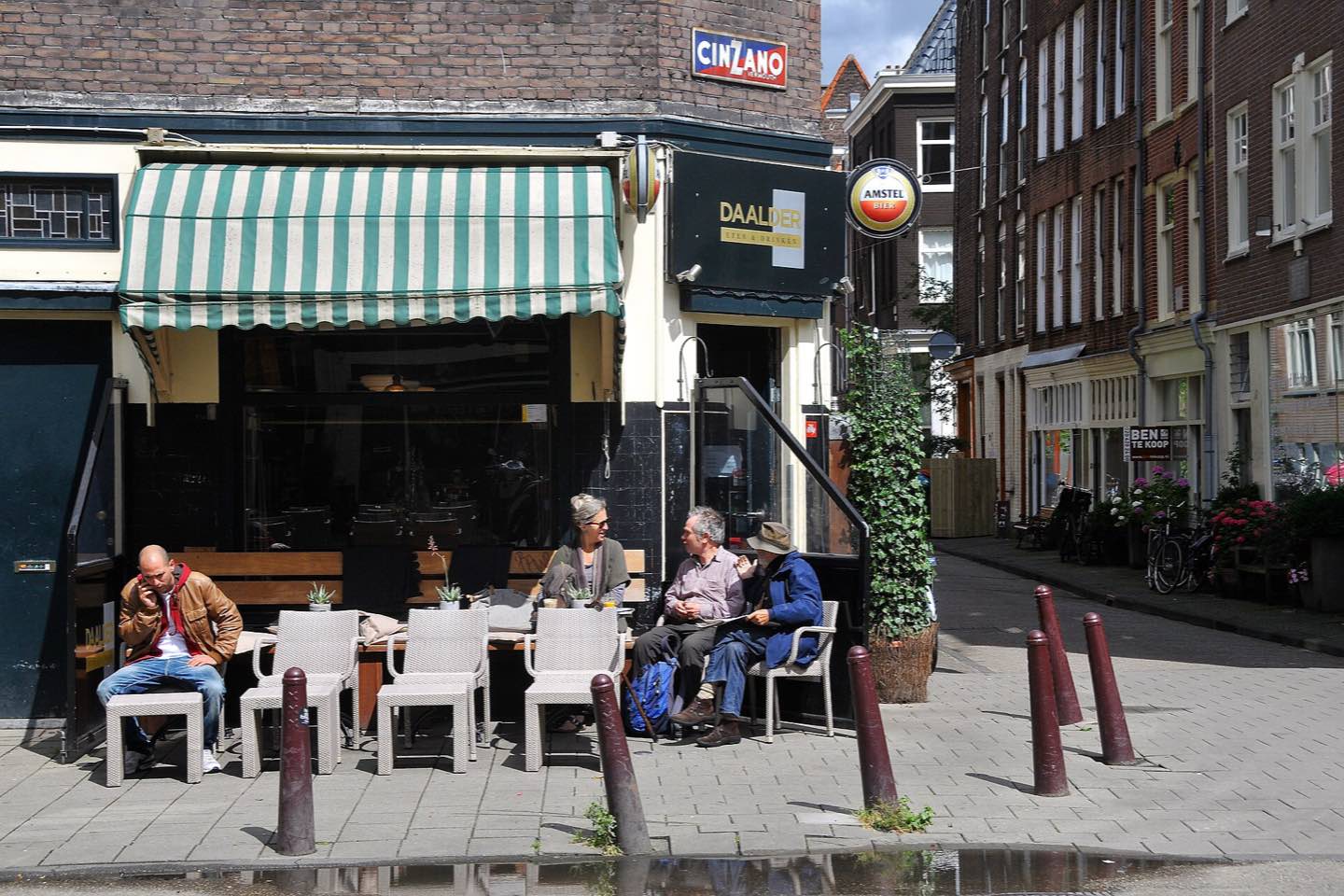 People on the terrace of a corner café on the Palmgracht in the Jordaan