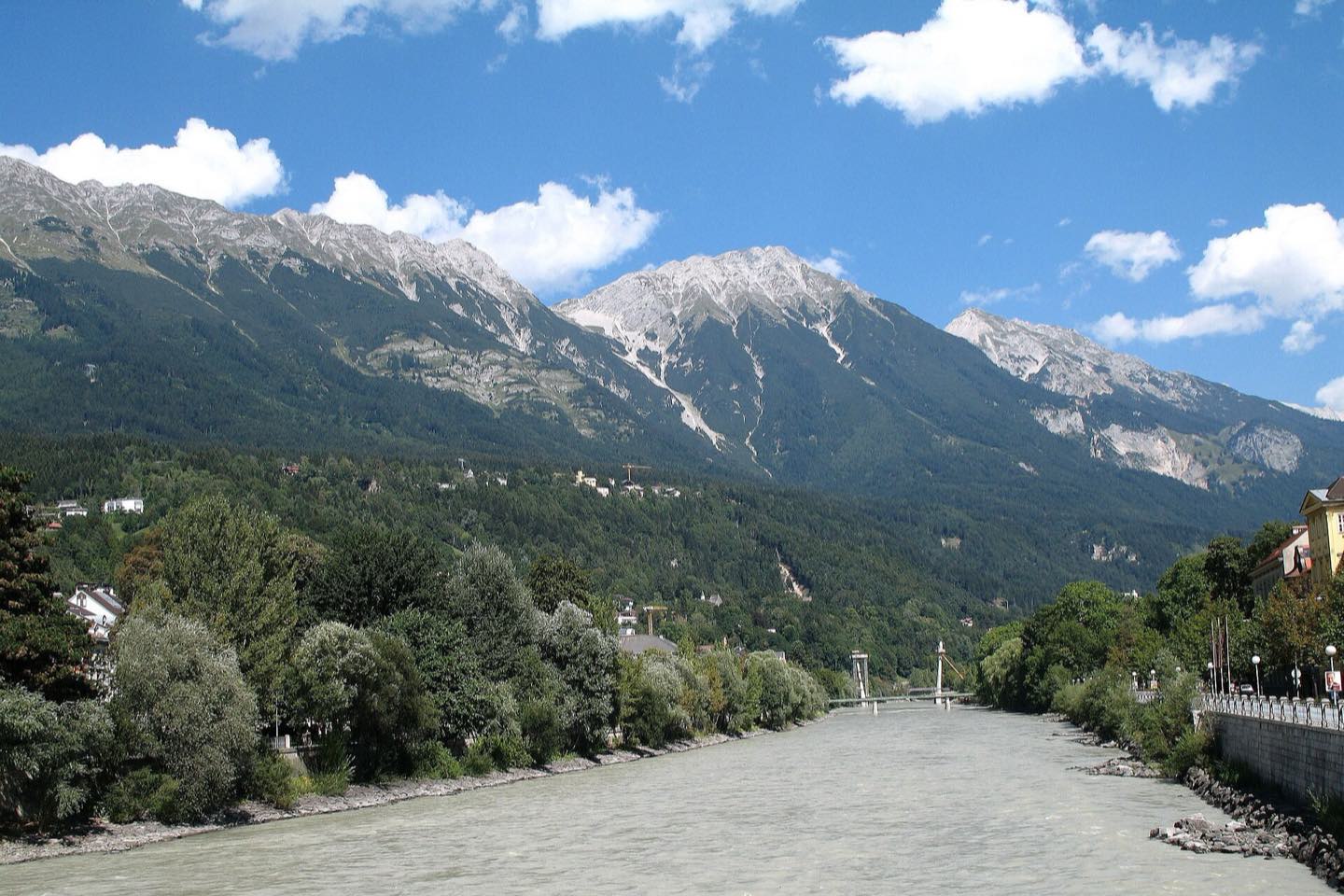 The Inn river flowing through Innsbruck beneath the Nordkette range