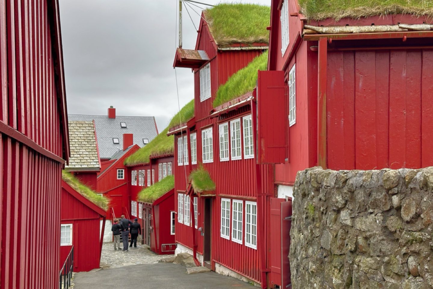 Red timber buildings with grass roofs in the Tinganes quarter of Tórshavn
