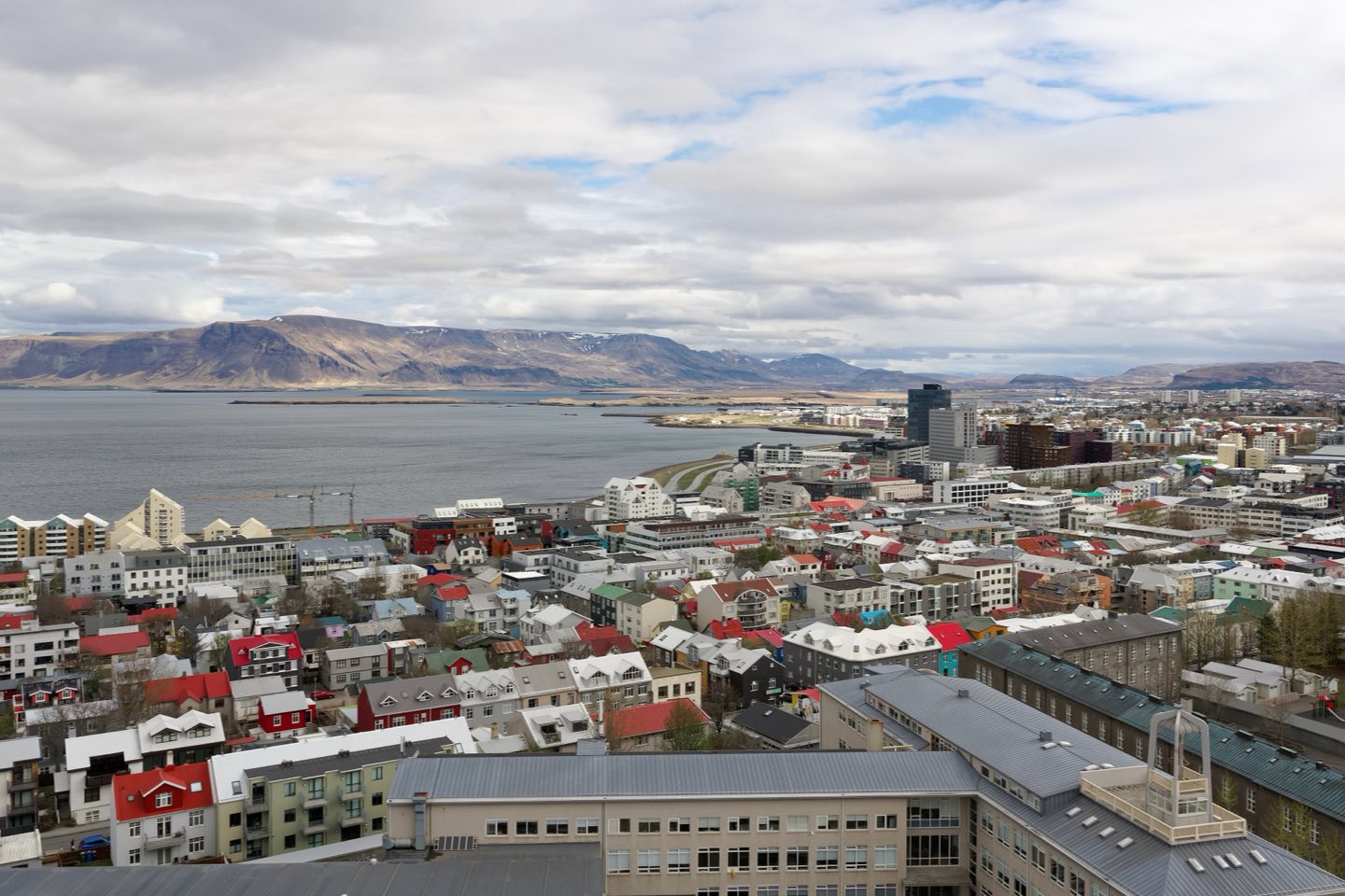 Colourful rooftops of central Reykjavík with Mount Esja across the bay