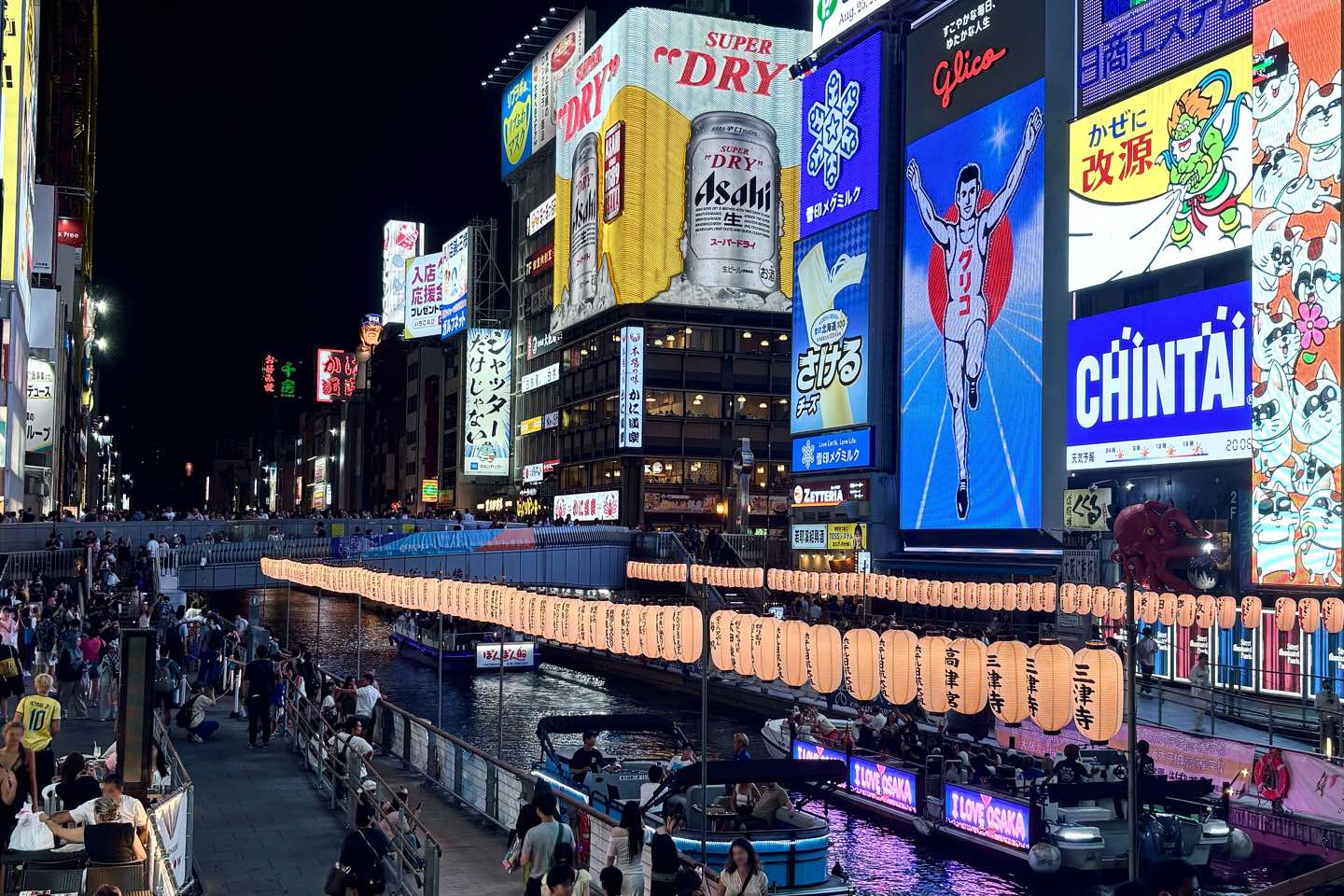 Neon signs and the Glico runner above the Dotonbori canal at night