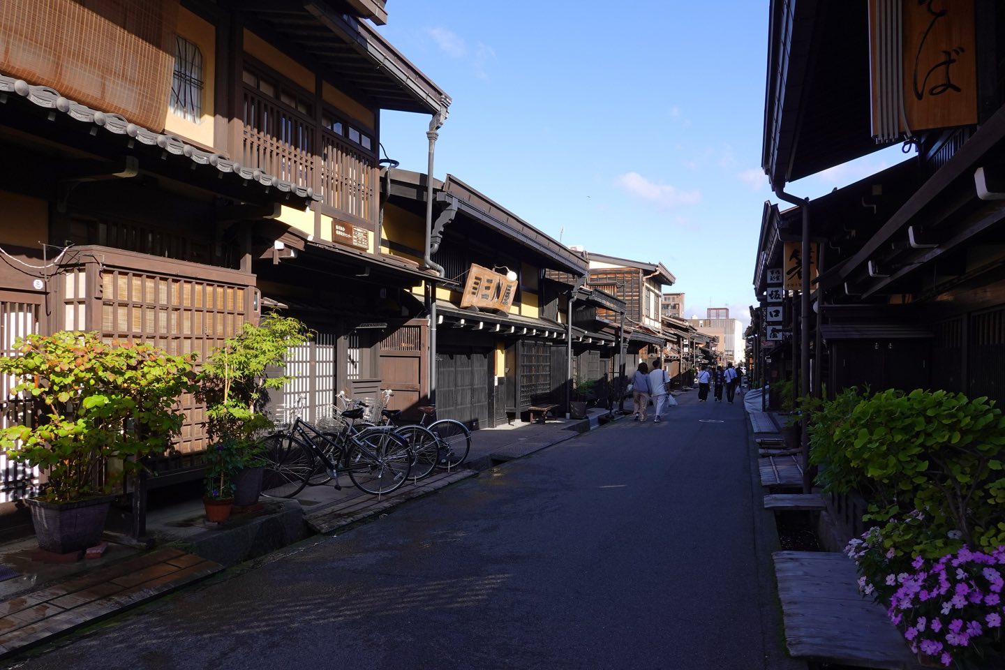 Dark wooden merchant houses along a lane in Takayama's Sanmachi Suji
