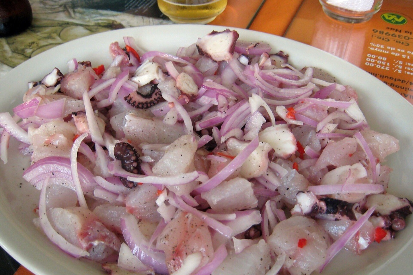 A plate of Peruvian ceviche with sweet potato and corn
