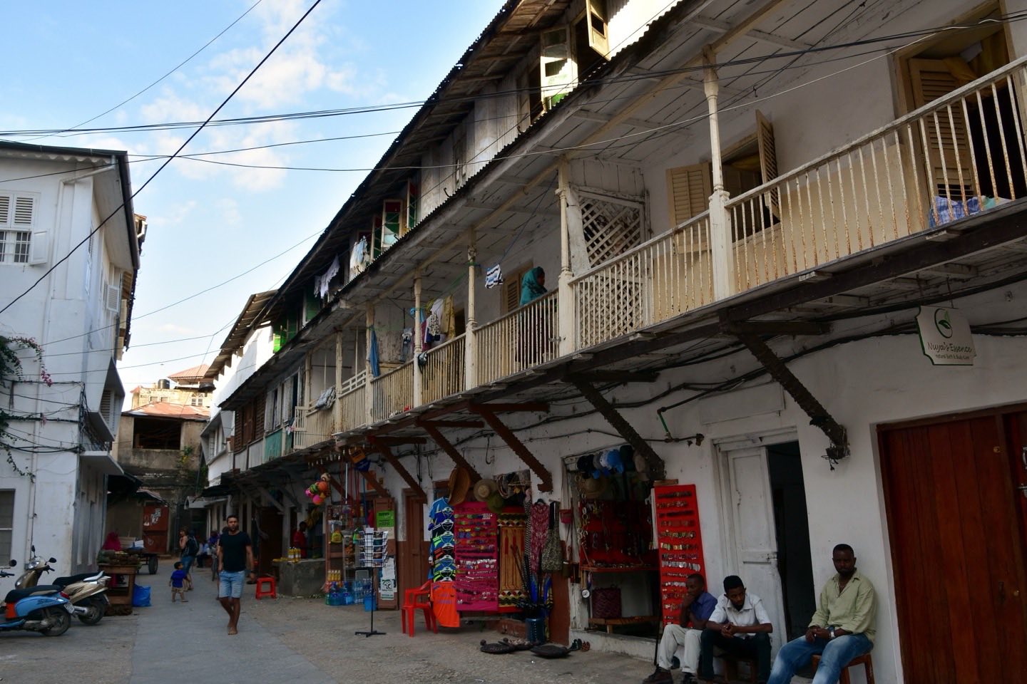 A Stone Town street of old buildings with wooden balconies and craft shops
